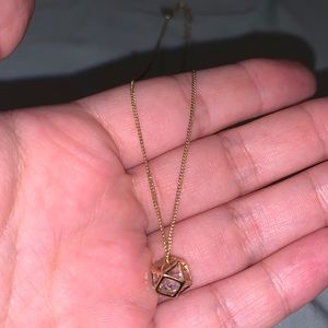 Gold geometric necklace with a diamond inside